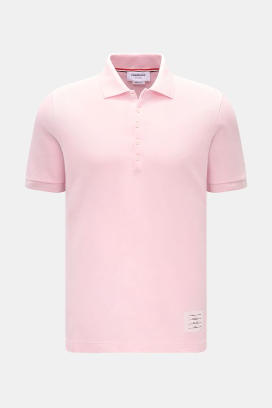 Thom Browne Poloshirt rosé, frontal fotografiert, Slim Fit aus reiner Baumwolle mit klassischem Polokragen, Fünf-Knopf-Leiste, Rippbündchen, elastischen Seiteneinsätzen und markentypischem Streifen-Logo. Thom Browne Poloshirt rosé, frontal fotografiert, Slim Fit aus reiner Baumwolle mit klassischem Polokragen, Fünf-Knopf-Leiste, Rippbündchen, elastischen Seiteneinsätzen und markentypischem Streifen-Logo.