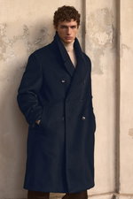 Shop by Look 05 Edition Vol. 19: front view of model wearing a black double-breasted Agnona cashmere coat with large buttons and wide collar, and a sand melange Aida Barni cashmere turtleneck sweater, creating a sophisticated, elegant cold-weather look.