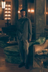 Front view of model in Shop by Look 17 Edition Vol. 19 wearing grey melange cashmere jacket from Zegna over cardigan by Fioroni, dark grey melange wool 'Carrot Fit' trousers from PT Torino, and black Chelsea boots 'Adrian' by Santoni in an elegant room.