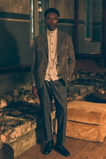 Front view of a model wearing a dark grey suede blazer from Rifugio over a light grey melange cashmere cardigan from Fioroni, paired with dark grey melange wool trousers in a 'Rebel Fit' from PT Torino and black 'Royal' penny loafers from Henderson, blend