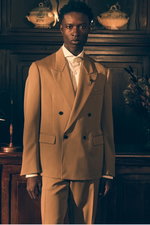 Front view of a model in Shop by Look 23 Edition Vol. 19, dressed in a light brown double-breasted Lardini blazer with peak lapels, white Borrelli Luciano shark collar shirt, and matching Lardini brown trousers.