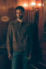 Front view of model in brown suede jacket, beige melange cashmere turtleneck, and grey-blue jeans by Brunello Cucinelli in Shop by Look 24 Edition Vol. 19.