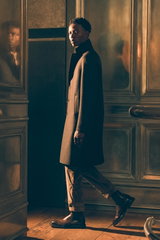 Side view of a model wearing a dark brown tailored wool coat from Harris Wharf London, brown Rebel Fit corduroy pants from PT Torino, and brown Officine Creative 'Dude Flexi' Chelsea boots in Shop by Look 25 Edition Vol. 19.