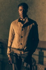 Front view of a model wearing a beige cashmere down blouson "Janos" from Moorer with high collar and buttons, paired with dark brown checkered "Retrolong" wool pants from Berwich, tailored fit and classic pattern, in Shop by Look 26 Edition Vol. 19.