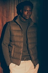 Shop by Look 27 Edition Vol. 19 shows a front view of a model in a brown melange down vest from Herno, dark brown cashmere turtleneck from FTC, cream 'Ben' chinos by Dondup, and dark brown braided belt from Officine Creative, blending rich browns with lig