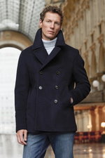 Front view of a man modeling Shop by Look 31 Edition Vol. 19, wearing a dark navy Sealup "Amalfi" pea coat, light grey Bruno Manetti cashmere turtleneck jumper, and dark blue Jacob Cohen "Bard" jeans.