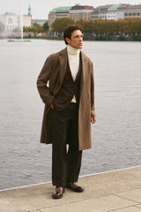 Shop by Look 04 Denis Cebulec in Lardini for BRAUN Hamburg, front view of model wearing brown/beige patterned coat, brown blazer, cream turtleneck, beige trousers, brown boots, by Lardini, Aida Barni, PT Torino, Officine Creative, stylish for cool day.